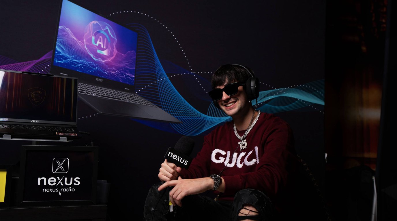 Thomas Deil seated with a Nexus Radio microphone and headphones in front of an MSI backdrop at the Nexus Lounge during Amsterdam Dance Event