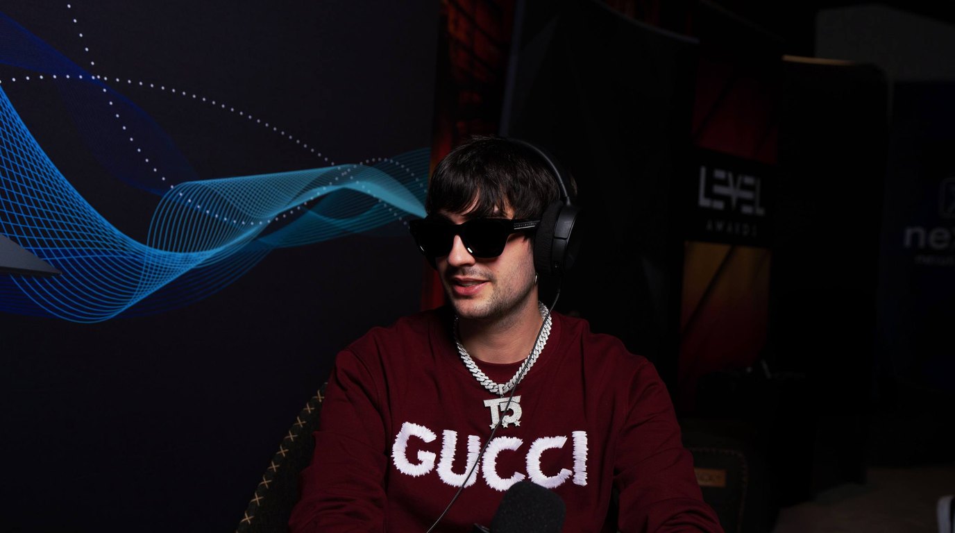 Close-up of Thomas Deil wearing headphones and holding a branded Nexus Radio microphone during an interview at the Nexus Lounge during Amsterdam Dance Event