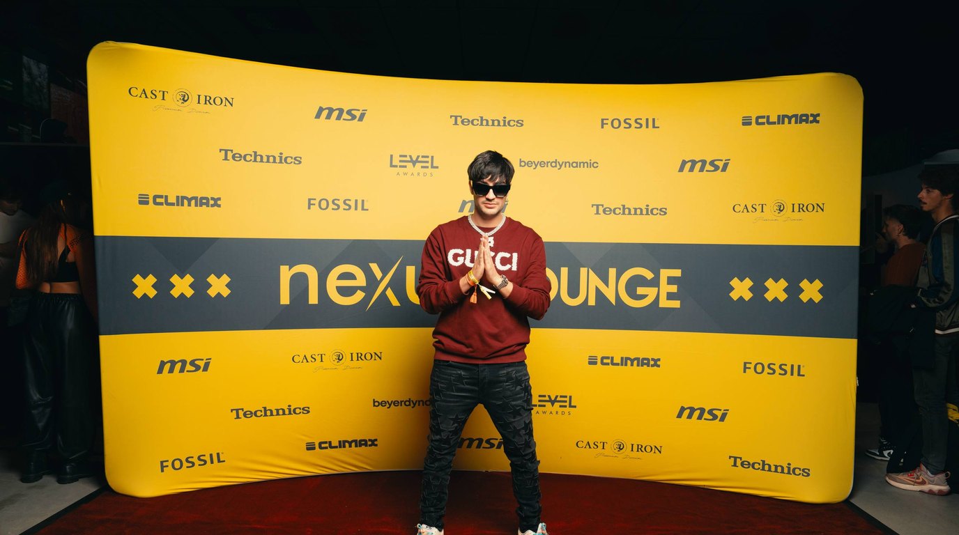 Thomas Deil standing against the yellow Nexus Lounge sponsor wall at Amsterdam Dance Event with Technics, MSI and Fossil logos repeating behind him